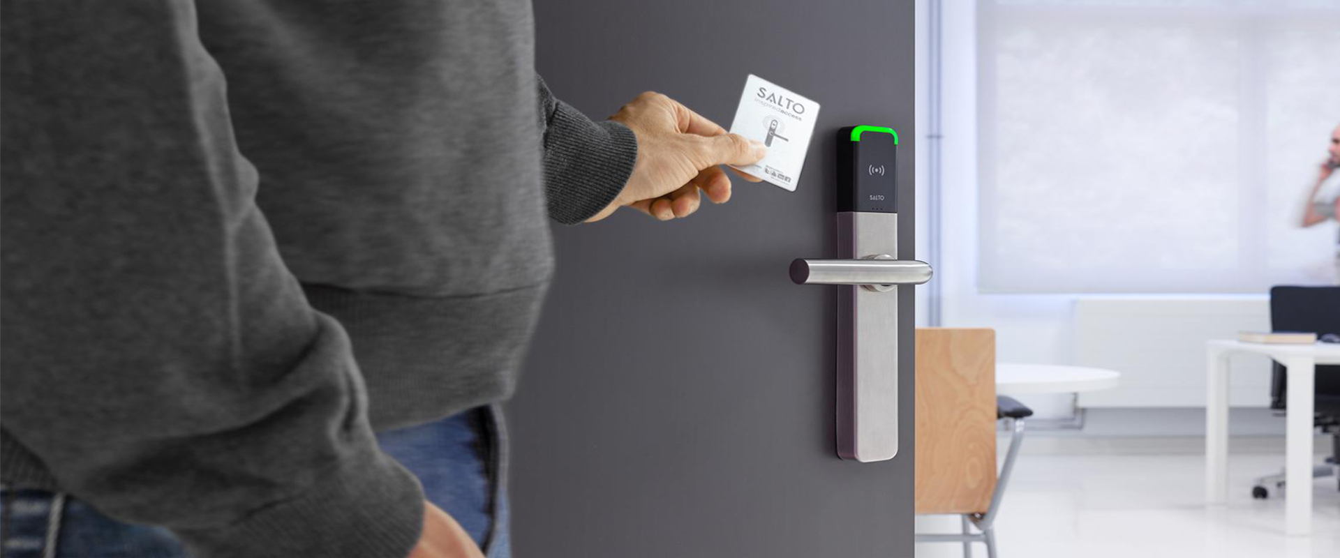 Staff member tapping a card on a commercial access control reader